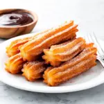 crispy homemade cinnamon sugar churros - featured image